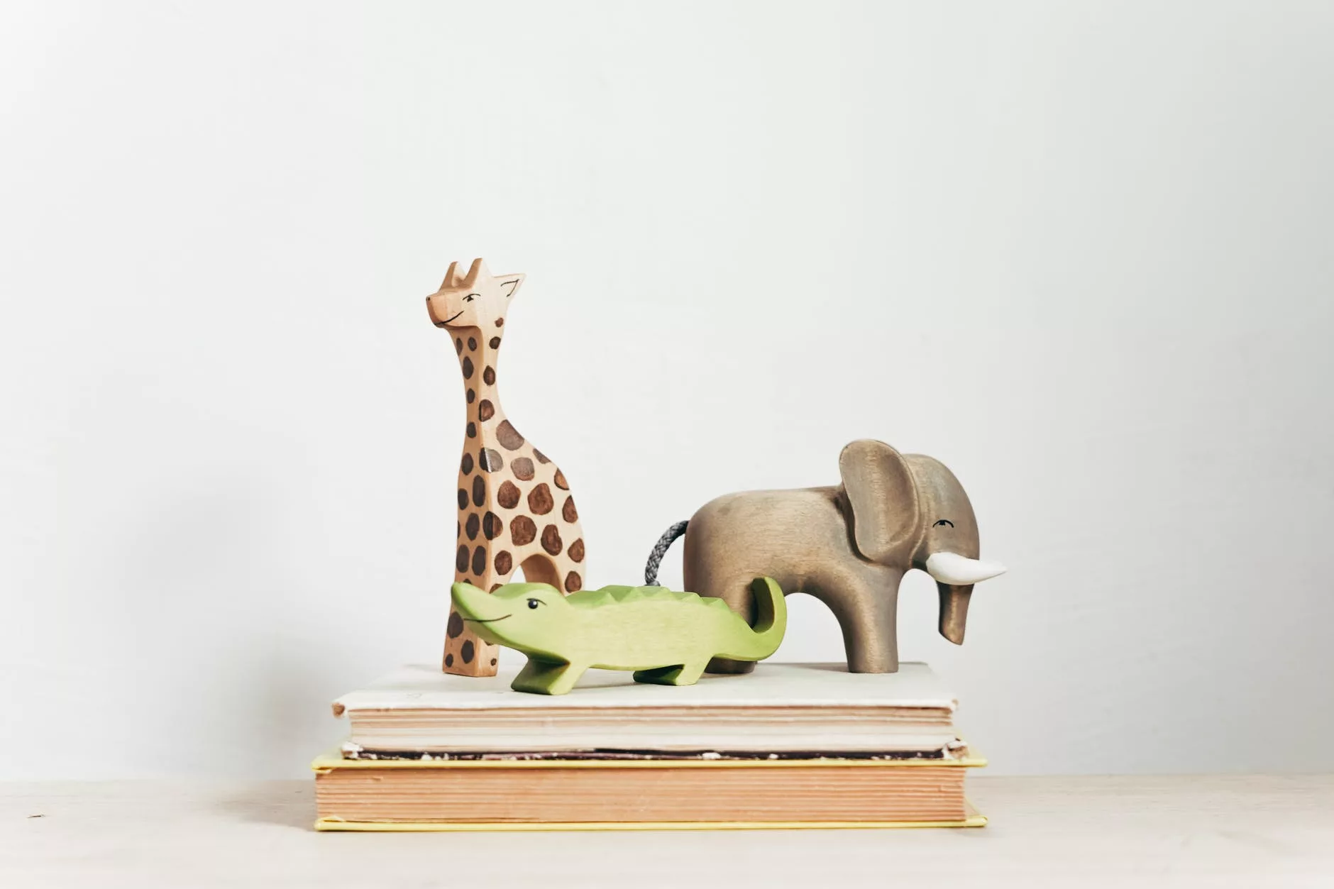 brown and green giraffe figurine on book